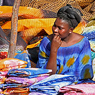 Woman selling colourful cloths on market in Nouakshott, Mauritania, Africa