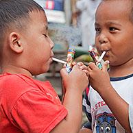 Indonesian children as young as three are being taught how to smoke by being allowed to puff away on home-made pipes called Popeye Lauts, Jakarta, Java, Indonesia