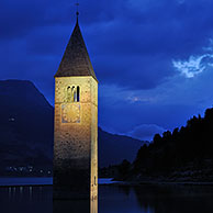 The submerged church tower at night in Lago di Resia at Curon Venosta / Graun, Dolomites, Italy