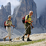 Couple of mountain walkers admiring the Tre Cime di Lavaredo / Drei Zinnen, Dolomites, Italy