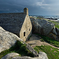 Old customs house wedged between the rocks at Menez Ham, Brittany, France