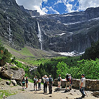 Tourists visiting the Cirque de Gavarnie and the Gavarnie Falls / Grande Cascade de Gavarnie, highest waterfall of France in the Pyrenees