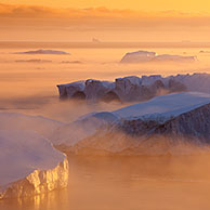 Icebergs, admitted onto UNESCO's World Heritage List, at sunset in the Kangia icefjord, Disko-Bay, West-Greenland, Greenland