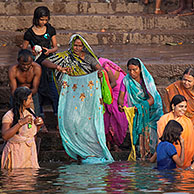 Indian people bathing and praying in the Ganges river at a ghat at Varanasi, Uttar Pradesh, India
