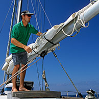 Yachtsman working on sailing boat, Mare, Tuscany, Italy