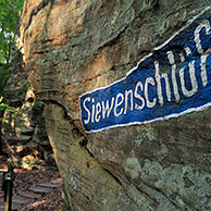 Siewenschlüff sign on sandstone rock at Wanterbaach in Berdorf, Little Switzerland  / Mullerthal, Grand Duchy of Luxembourg
