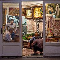 Men selling carpets in carpet store in the old historic bazaar of the city Tabriz, East Azerbaijan, Iran