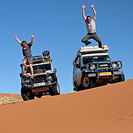 Four-wheel drive vehicles on sand dune in the Namib desert, Namibia, South Africa