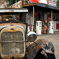 Old Ford car in front of the General Store along the historic Route 66 with vintage gas pumps and a plethora of classic signs and memorabilia, Hackberry, Arizona