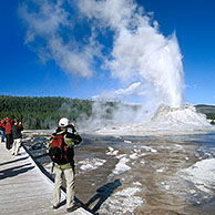 Tourists at the Castle geyser, Yellowstone National Park, Wyoming, USA 